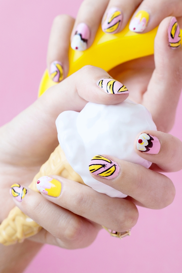 Someone holding fake ice cream with banana split nails