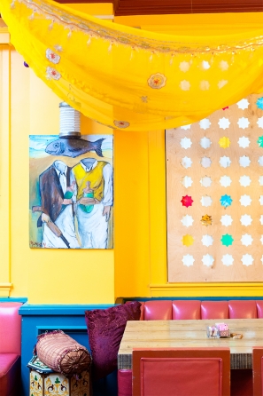 Yellow room with art on the walls