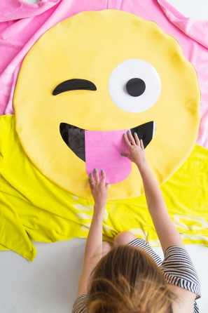 Someone holding an emoji pillow