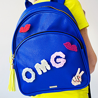 A blue backpack that says "OMG"