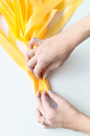 Someone folding yellow paper