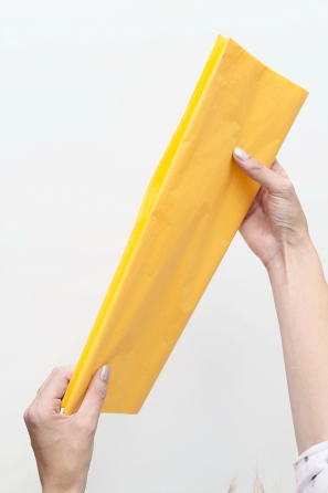 Someone holding yellow paper