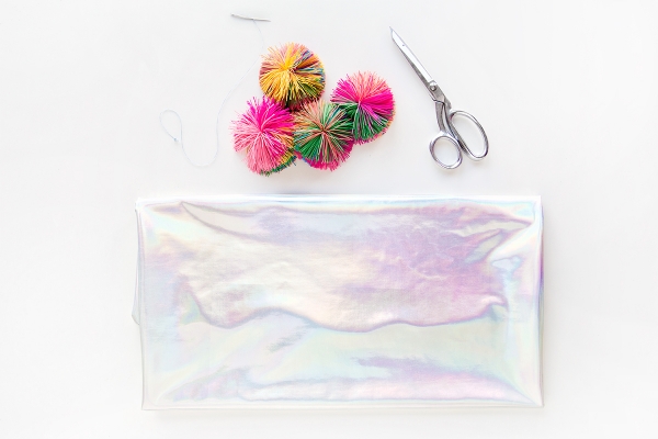 Holographic fabric, scissors, and colorful balls