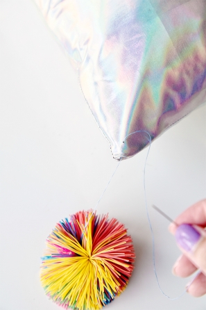 A close up of a pillow corner and a colorful ball