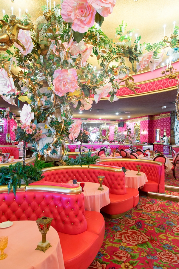 A room with pink couches and flowers