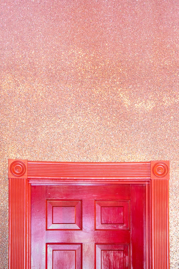 A door frame and pink wall