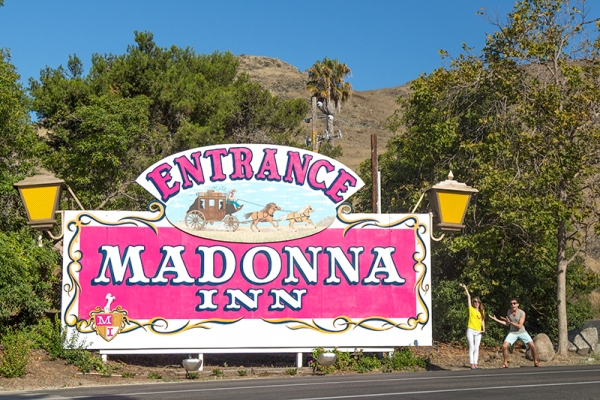 A pink sign that says \"entrance madonna inn\"