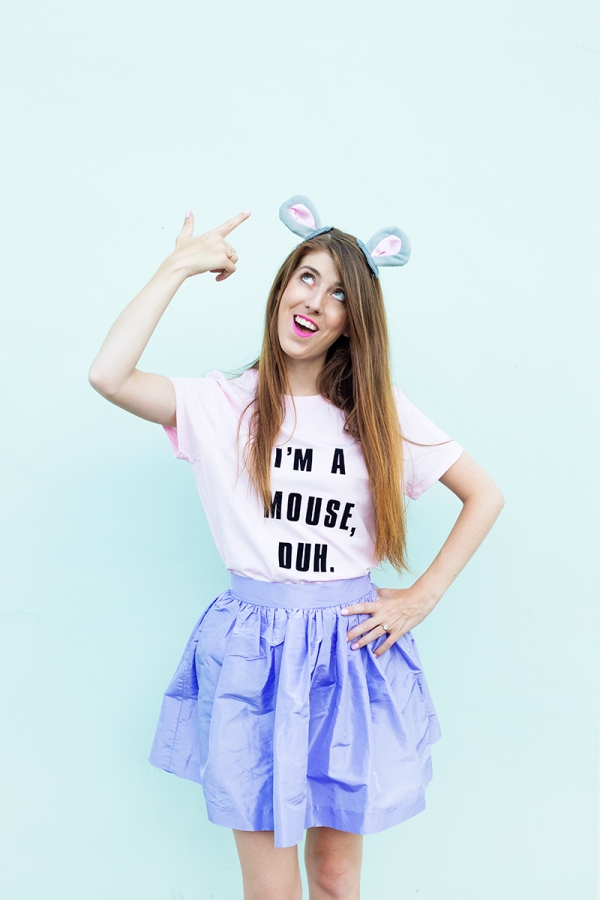 A woman wearing mouse ears and a pink shirt