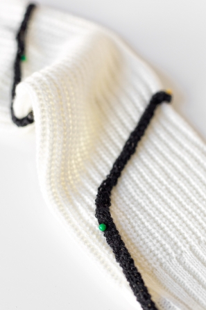 Black yarn on a white sweater