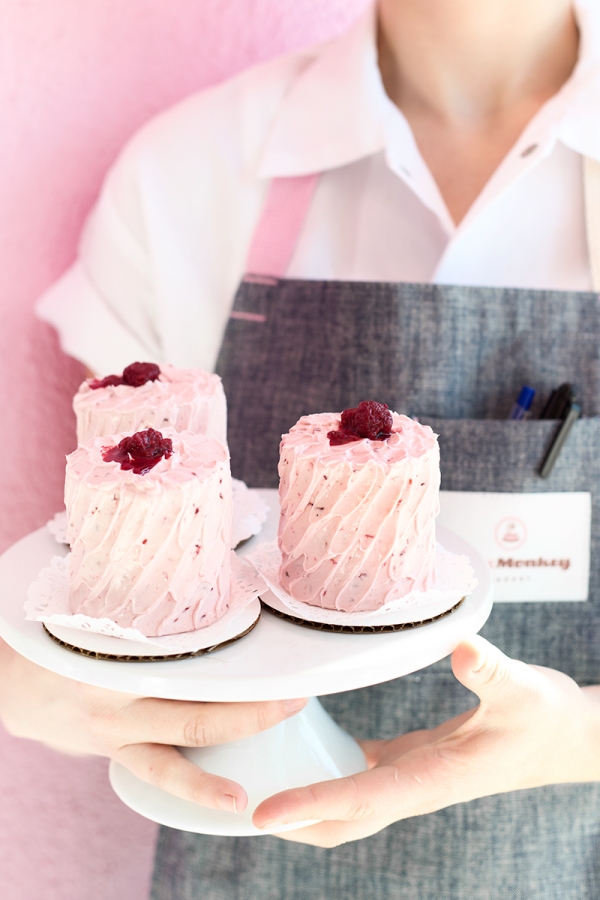 Someone holding pink desserts