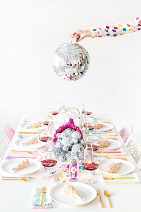 A dining table with decor and disco balls 