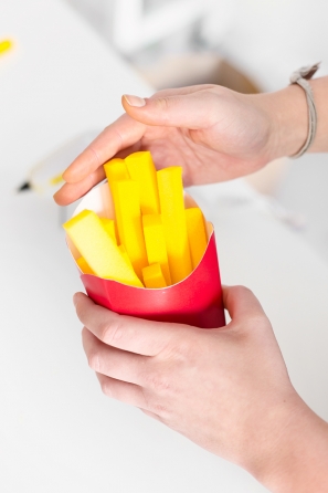 Someone holding a fake pack of fries