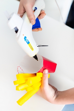 Someone gluing a fry holder 