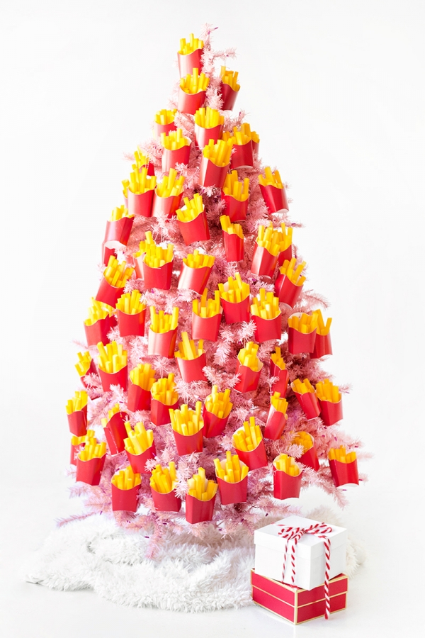 A pink christmas tree covered in fry ornaments 