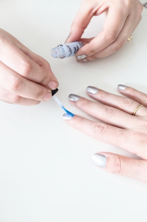 A woman getting her nails painted 