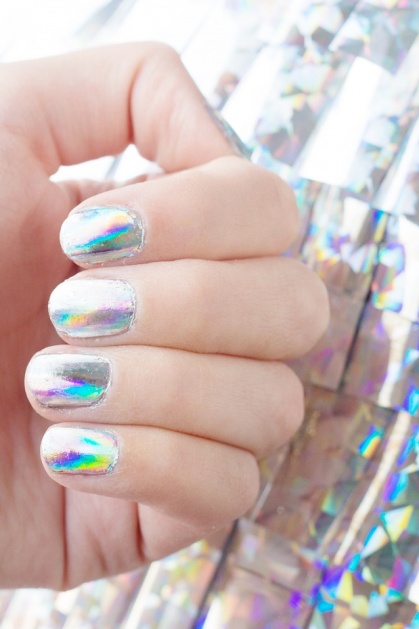 A hand with holographic nails 