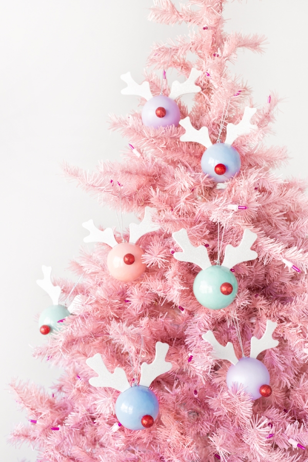 A pink christmas tree with ornaments 