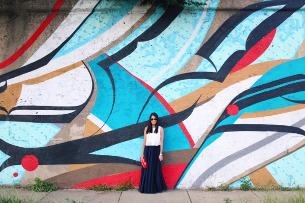 A woman standing in front of a colorful wall