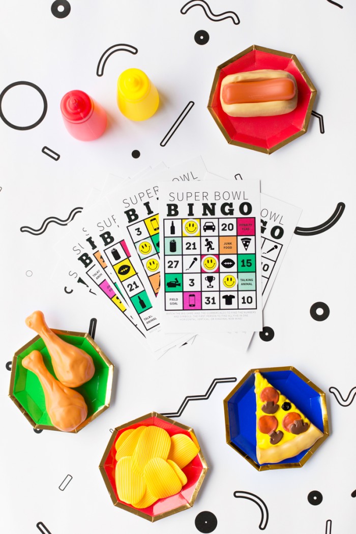 super bowl bingo cards surrounded by play food on plates