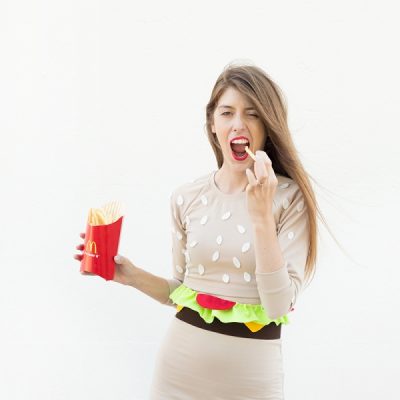 A woman wearing a hamburger costume