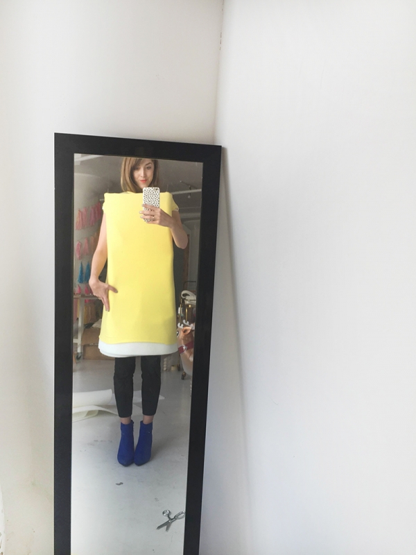 A person standing in front of a mirror posing for the camera