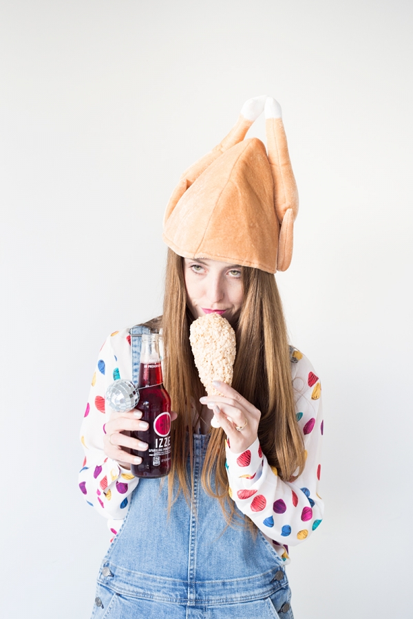 A woman wearing a chicken hat