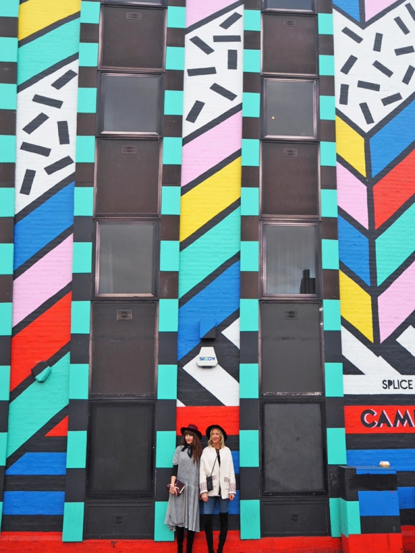 People standing in front of a patterned wall