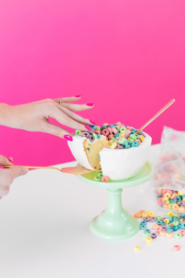 Someone touching a cereal bowl cake