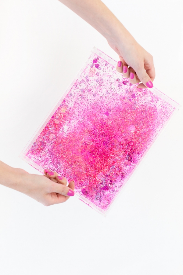Someone holding a plastic bag with pink glitter