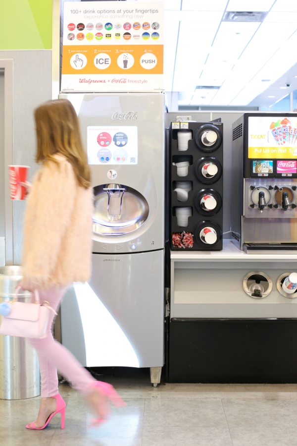 A woman next to a drink machine