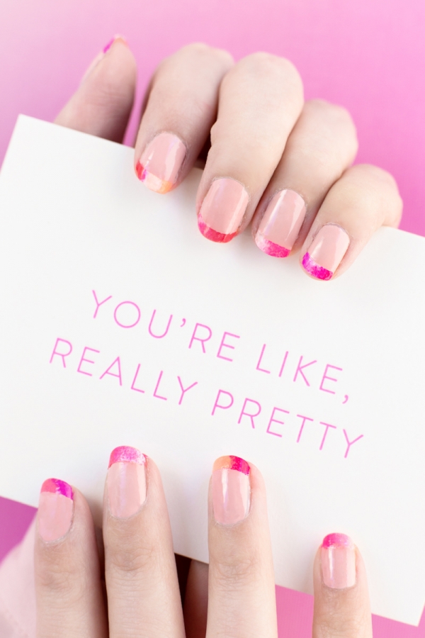 Someone holding a card with pink writing on it