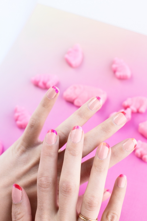 Hands with pink nail polish on it