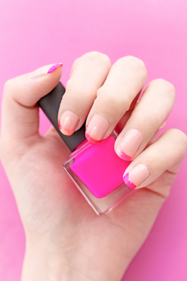 Someone holding hot pink nail polish