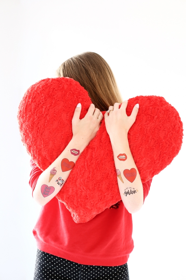 Someone holding a red heart pillow