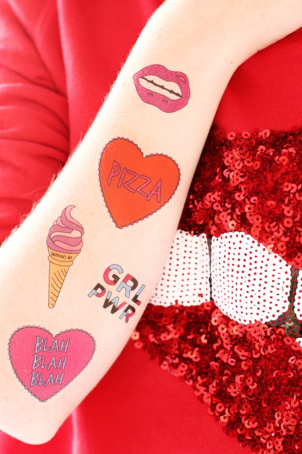 An arm with valentines stickers on it