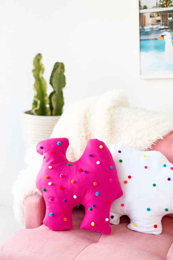 Circus animal cookie pillows on a pink couch