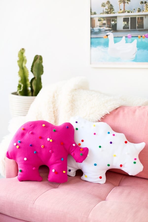 Circus animal cookie pillows on a pink couch