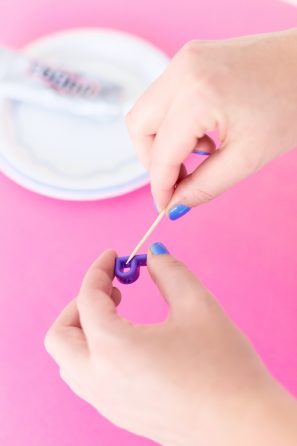 Someone holding a purple \"P\" candle