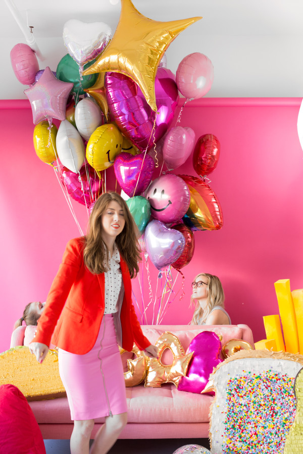 A woman and a bunch of balloons
