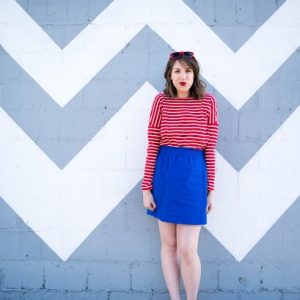 A woman standing in front of patterned wall