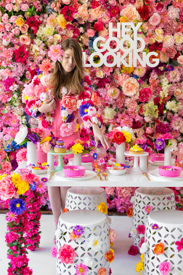 A table in front of a wall of flowers