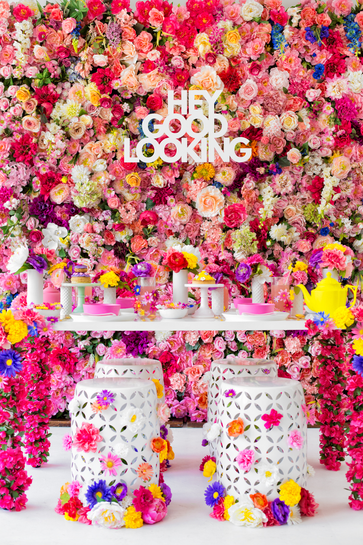 A table in front of a wall of flowers