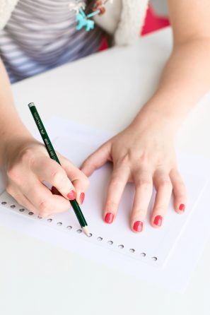 Someone drawing on a notebook