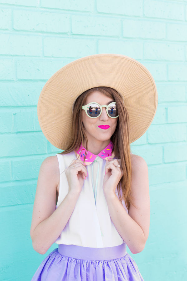 A woman wearing sunglasses and a hat posing for the camera