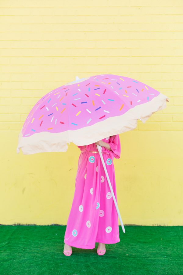 Someone wearing a pink dress and holding a pink umbrella 