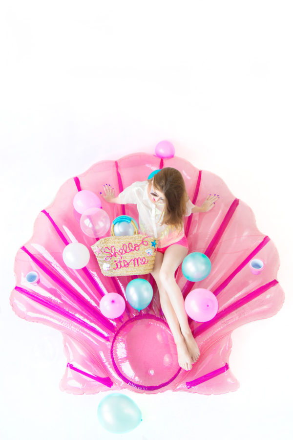 A woman sitting on a shell floatie