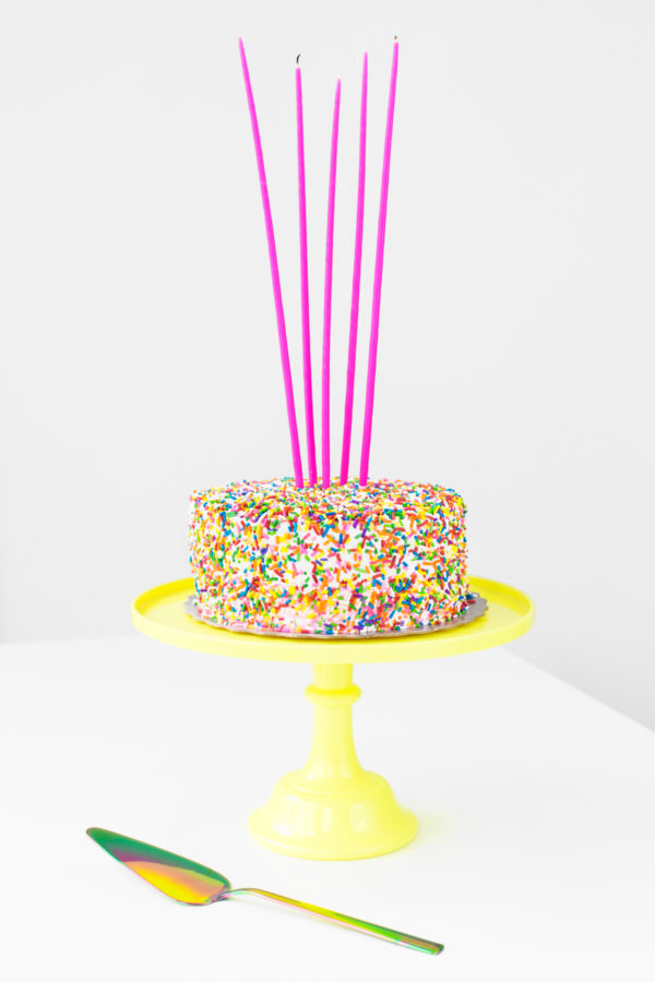A cake with sprinkles and candles