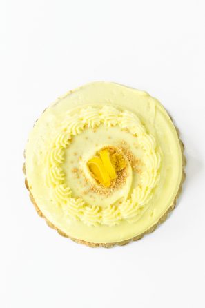 A cake with yellow frosting