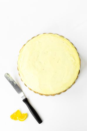 A cake with yellow frosting on it