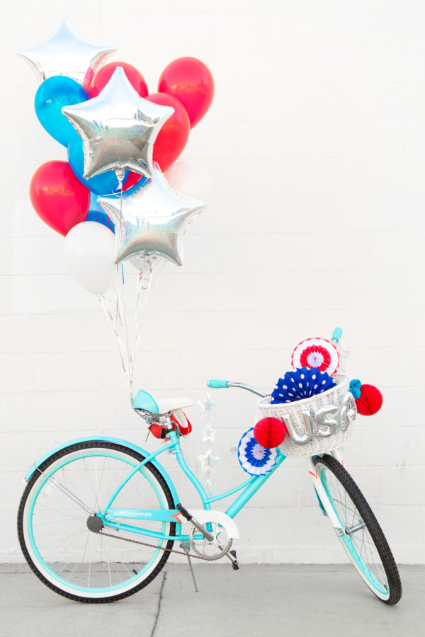 A bicycle with balloons attached to it